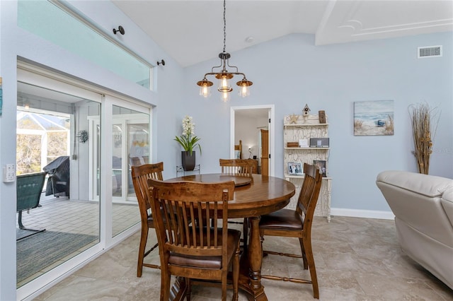 dining room featuring visible vents, baseboards, a chandelier, and vaulted ceiling