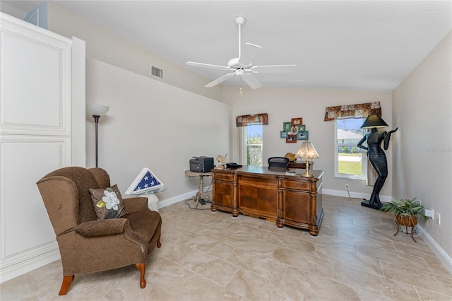 office area with lofted ceiling, a ceiling fan, visible vents, and baseboards