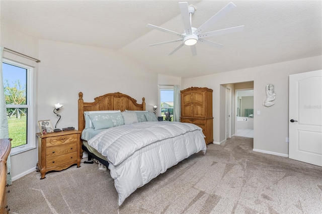 bedroom featuring light colored carpet, baseboards, lofted ceiling, and ceiling fan