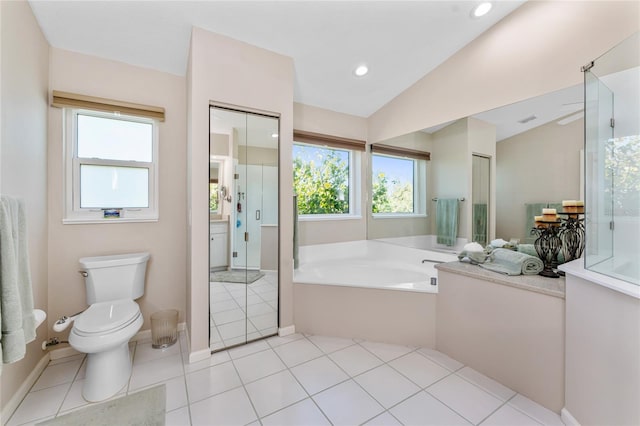 bathroom featuring toilet, a garden tub, plenty of natural light, and vaulted ceiling