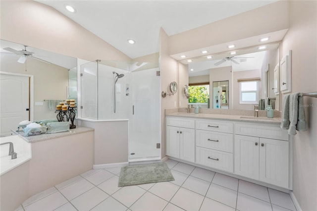 bathroom featuring ceiling fan, lofted ceiling, double vanity, a stall shower, and a sink