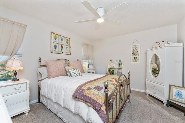 bedroom featuring a ceiling fan, light colored carpet, and baseboards