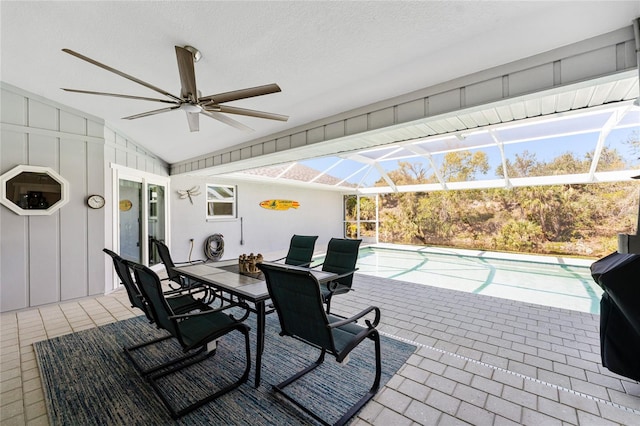 view of patio / terrace featuring a lanai, outdoor dining area, an outdoor pool, and ceiling fan