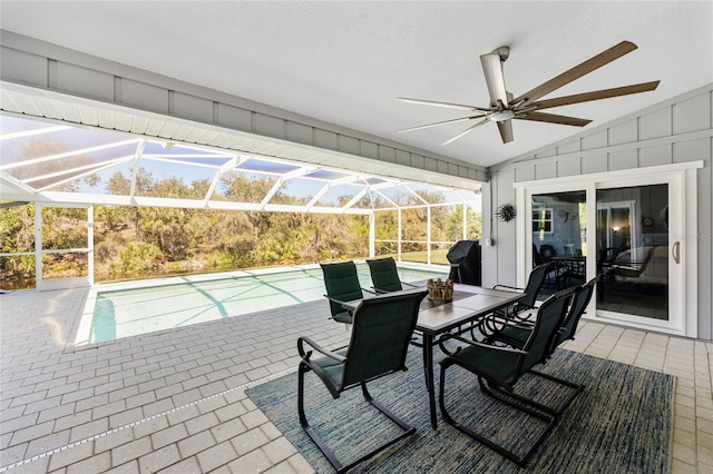 view of patio with glass enclosure, outdoor dining space, an outdoor pool, and ceiling fan