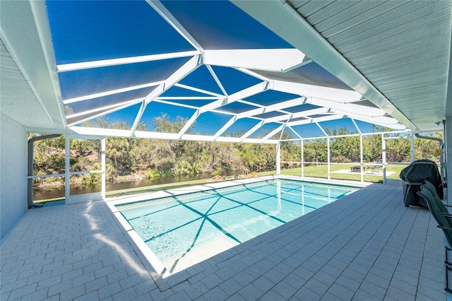 outdoor pool with glass enclosure and a patio