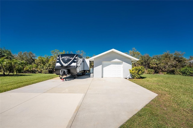 view of front of house with a garage, concrete driveway, and a front lawn