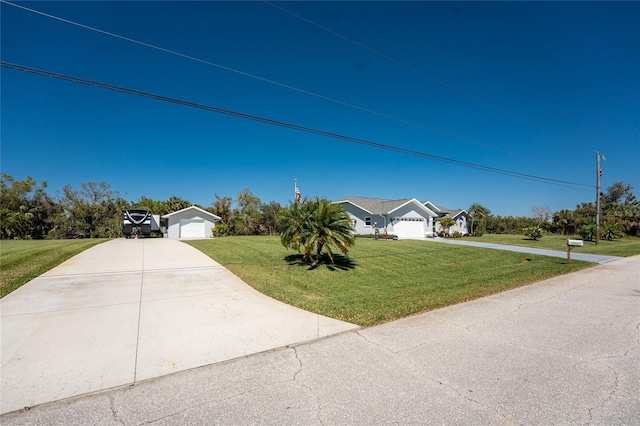 view of front of house with a garage, driveway, an outdoor structure, and a front lawn