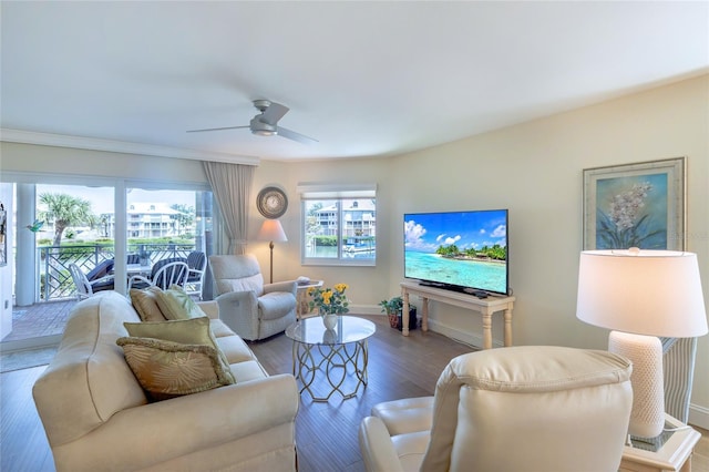 living room with baseboards, a ceiling fan, and wood finished floors