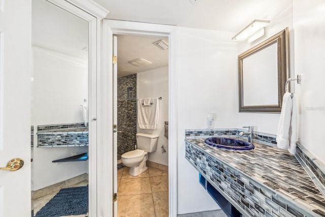 bathroom with visible vents, vanity, toilet, and tile patterned floors