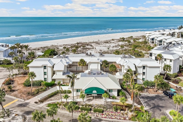 aerial view with a residential view, a water view, and a beach view