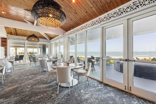 sunroom featuring french doors, a water view, an inviting chandelier, wood ceiling, and vaulted ceiling