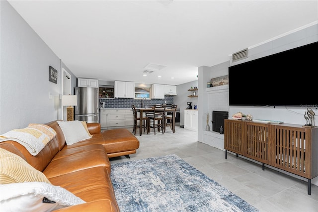 living area with visible vents and a fireplace