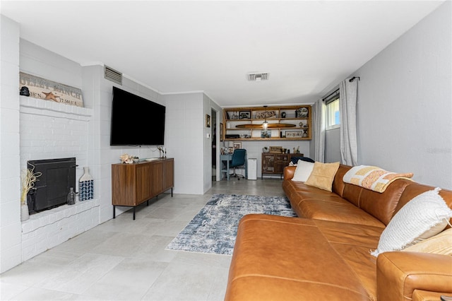 living room featuring a fireplace and visible vents