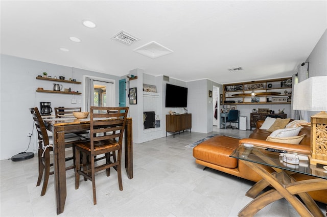 living room with recessed lighting, visible vents, and attic access