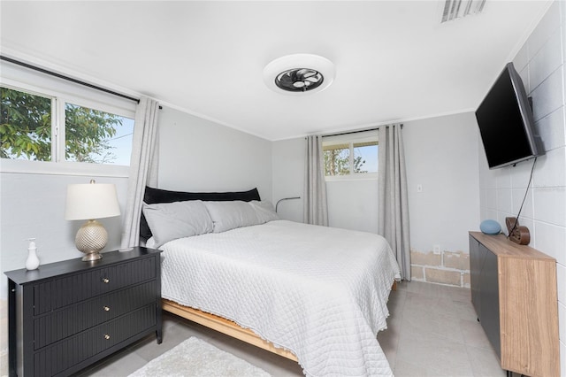 bedroom with ornamental molding and visible vents