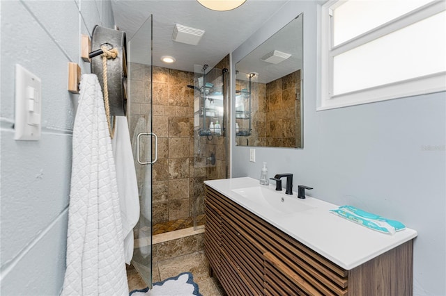 bathroom featuring a shower stall, visible vents, and vanity