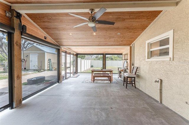 view of patio / terrace with ceiling fan and fence