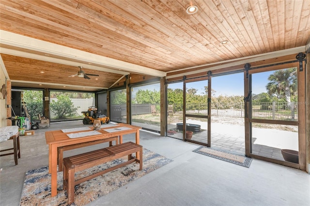 sunroom / solarium with vaulted ceiling, wooden ceiling, and a ceiling fan