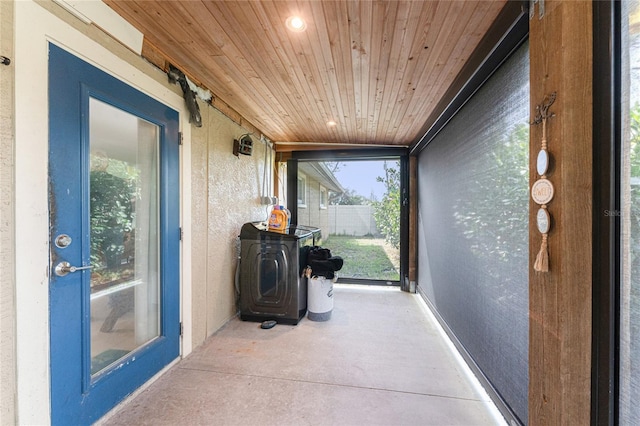 sunroom / solarium featuring wooden ceiling