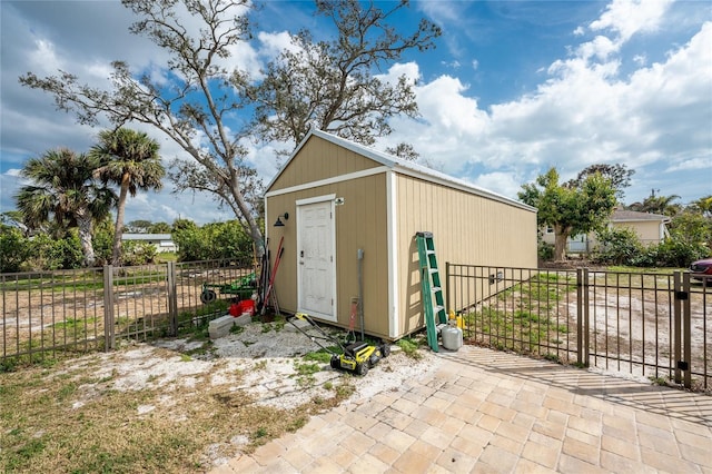 view of outbuilding featuring an outdoor structure and fence