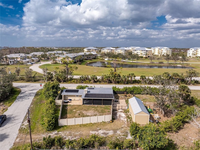 birds eye view of property with a water view and a residential view