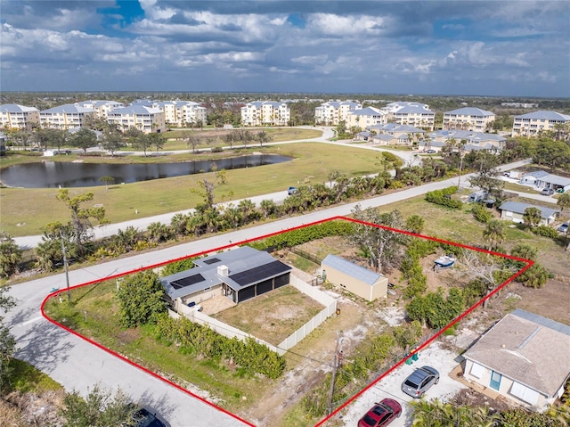 birds eye view of property with a water view and a residential view