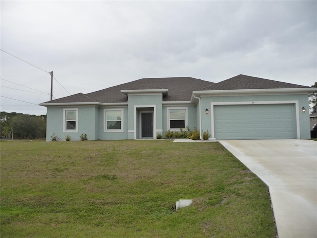 view of front of home with driveway, an attached garage, a front yard, and stucco siding