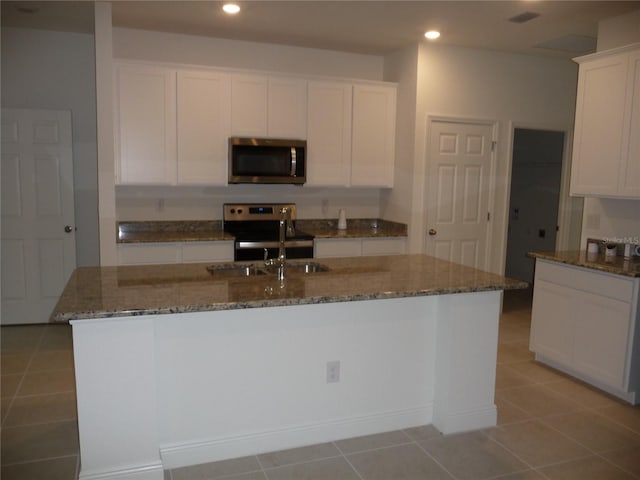 kitchen featuring appliances with stainless steel finishes, recessed lighting, stone counters, and white cabinets