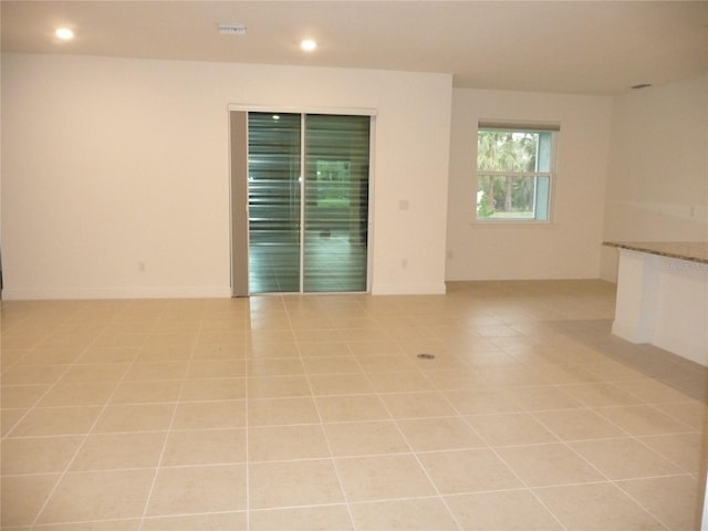 unfurnished room featuring light tile patterned floors, baseboards, visible vents, and recessed lighting