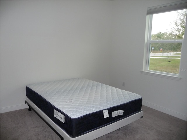 bedroom with carpet flooring and baseboards