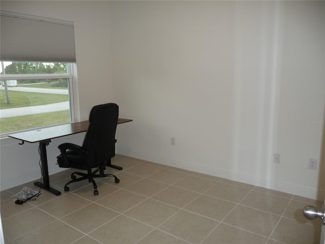 office space with tile patterned flooring and baseboards