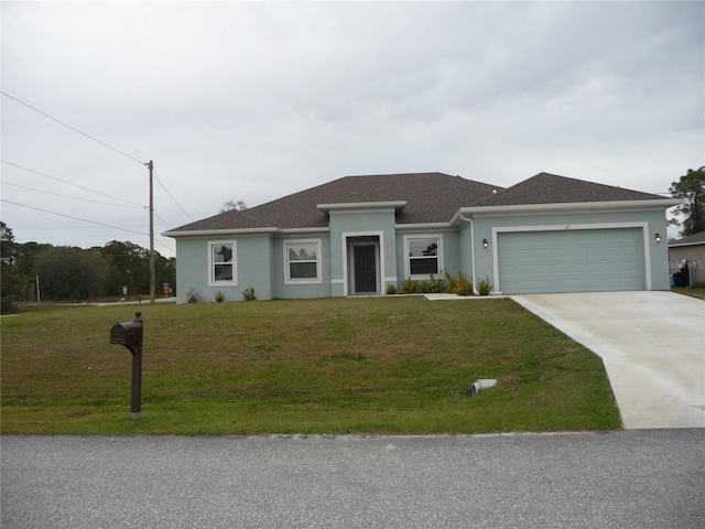 view of front of property featuring a garage, driveway, a front lawn, and stucco siding