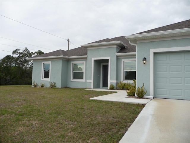 view of front of house with a garage, a shingled roof, a front yard, and stucco siding