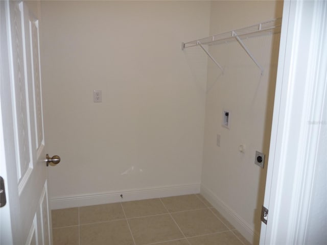 washroom featuring baseboards, laundry area, light tile patterned flooring, and hookup for an electric dryer