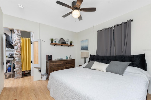 bedroom with light wood-type flooring and a ceiling fan