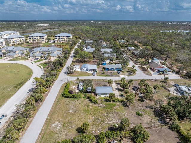 bird's eye view featuring a residential view and a wooded view