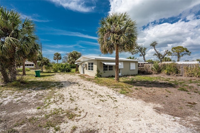 exterior space featuring driveway and fence