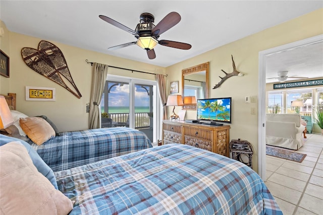 bedroom featuring tile patterned floors, multiple windows, a ceiling fan, and access to outside