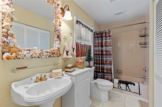 full bath featuring tile patterned flooring, visible vents, toilet, shower / tub combo with curtain, and a sink