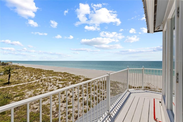 balcony with a beach view and a water view