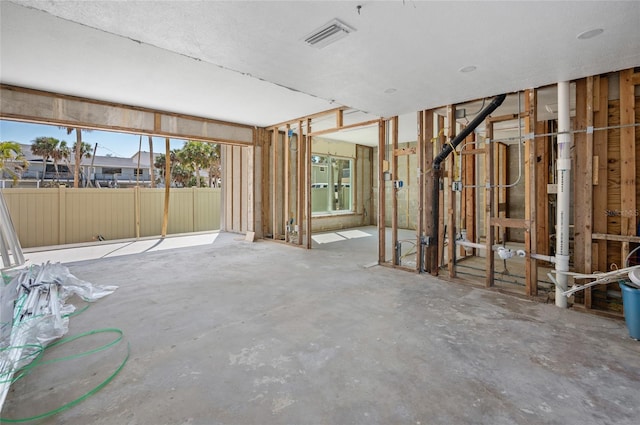 interior space with unfinished concrete flooring and visible vents