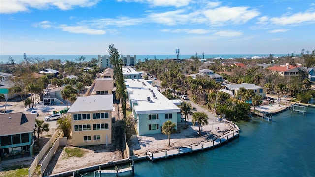 birds eye view of property with a water view and a residential view