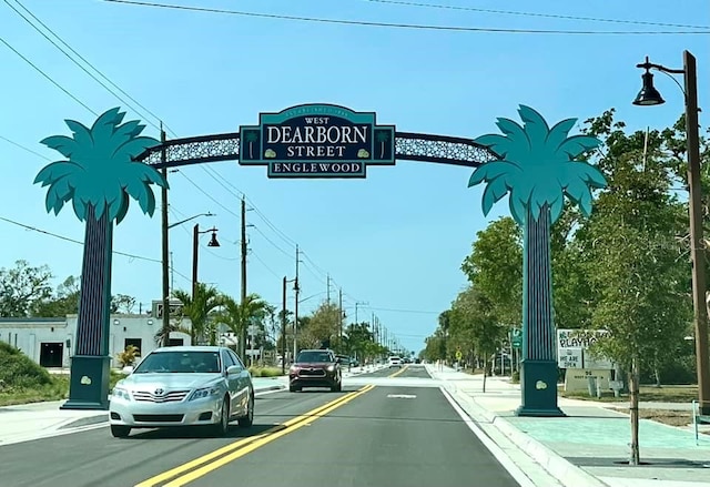 view of street featuring street lights, curbs, and sidewalks