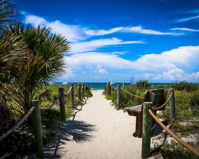 surrounding community with a beach view and a water view