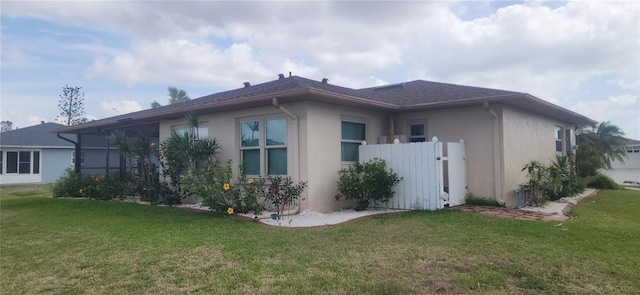 view of property exterior featuring a lawn and stucco siding