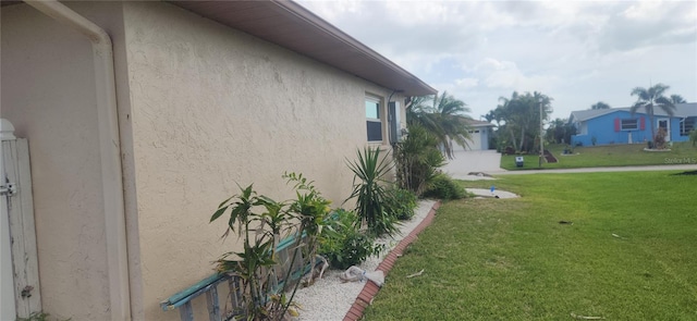 view of property exterior featuring a yard and stucco siding