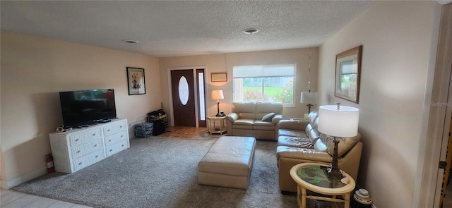 carpeted living room featuring visible vents and a textured ceiling