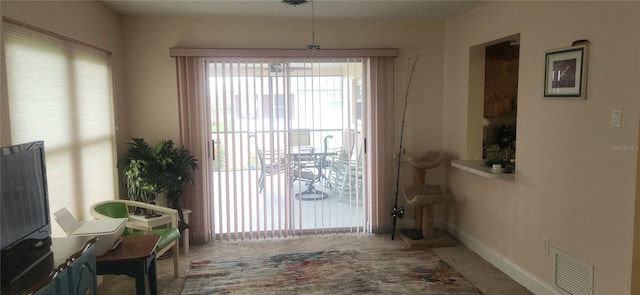 doorway featuring carpet flooring, visible vents, and baseboards