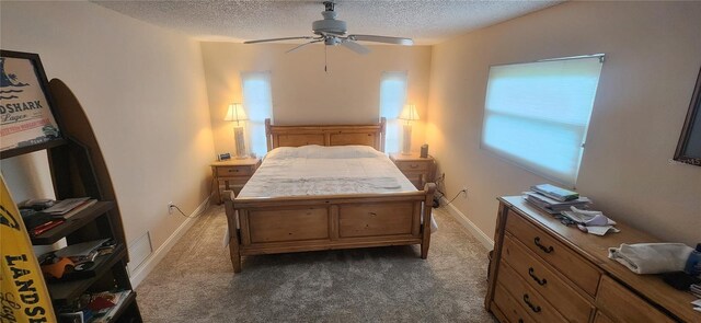 bedroom with baseboards, dark carpet, ceiling fan, and a textured ceiling