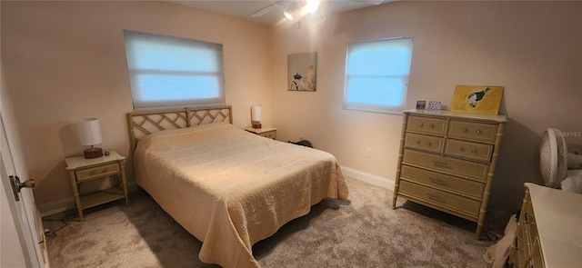 bedroom with baseboards and light colored carpet